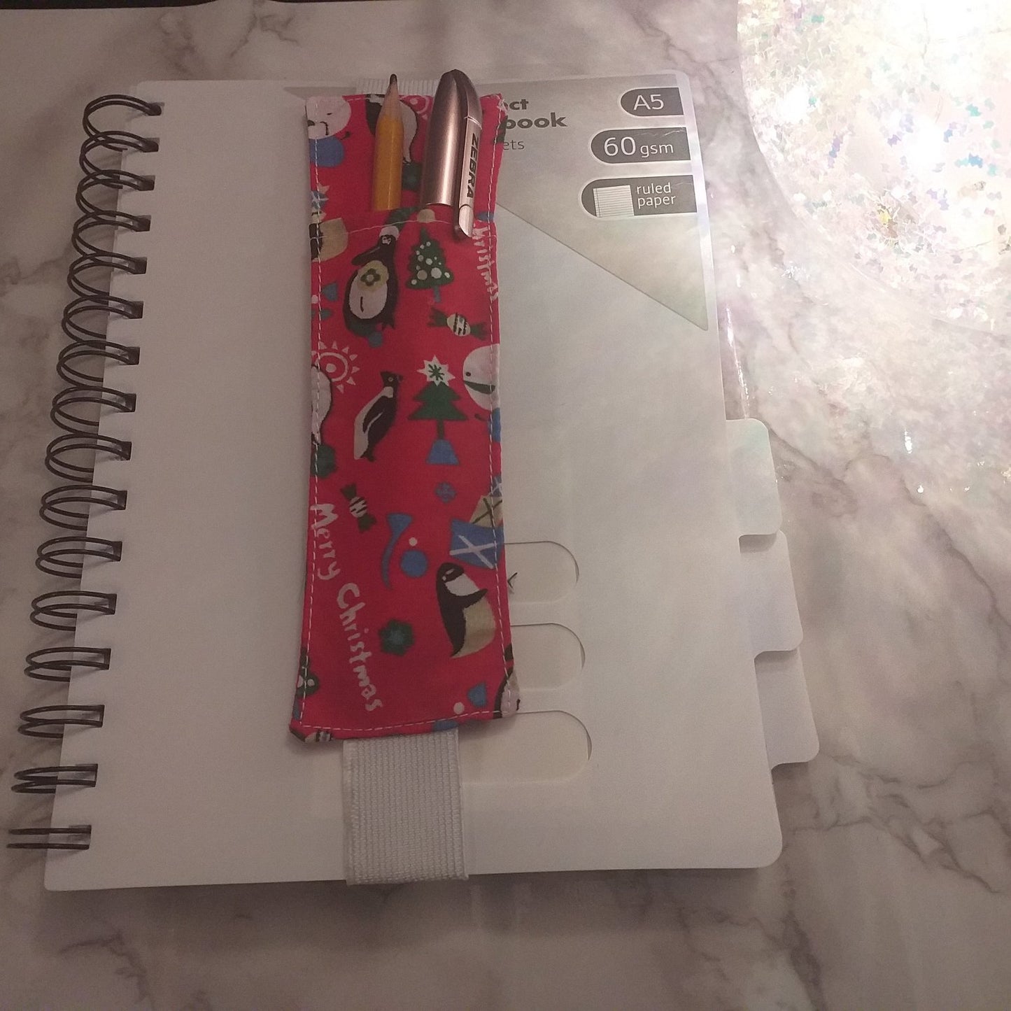 Notebook pen holder